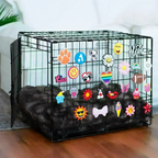 Pet crate accessories multicolor crate charms collection decorating black wire dog crate in home environment Crate Charms brand lifestyle setup