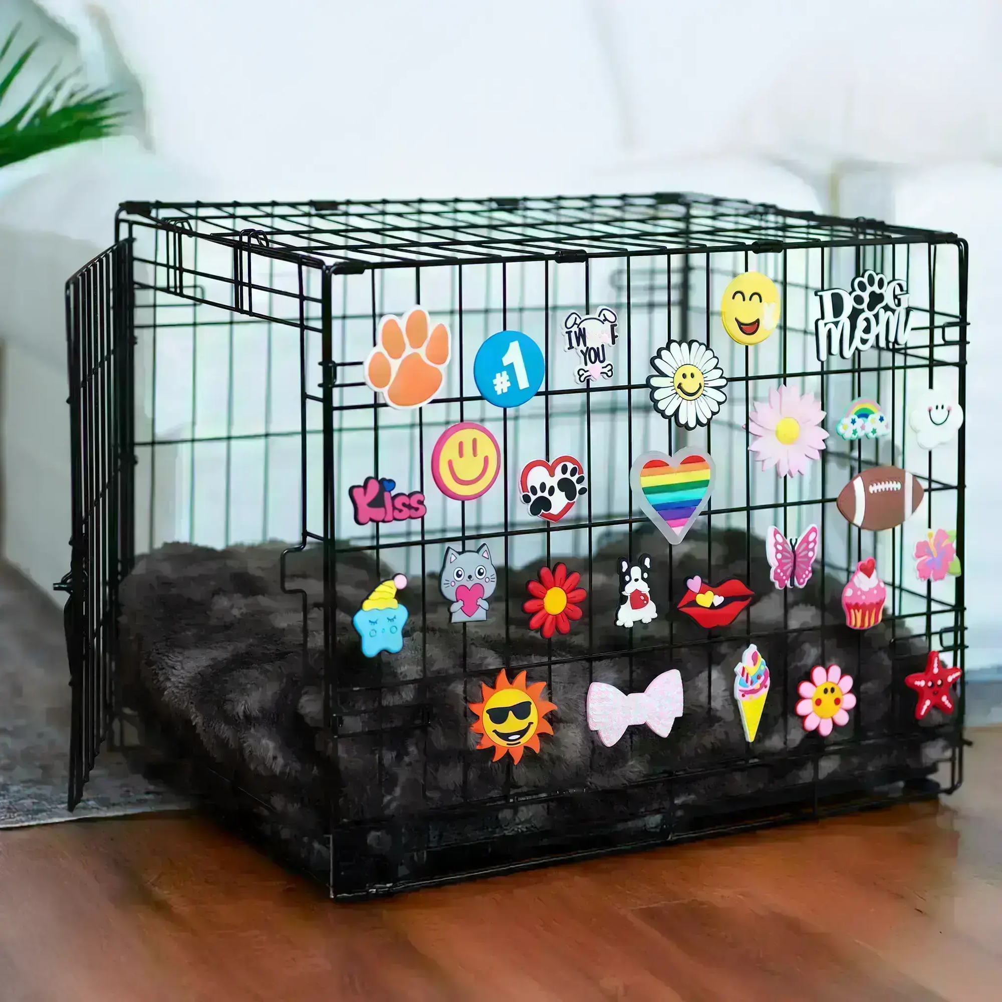 Pet crate accessories multicolor crate charms collection decorating black wire dog crate in home environment Crate Charms brand lifestyle setup